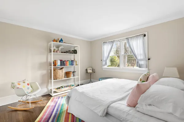 a bedroom with a bed and a large window