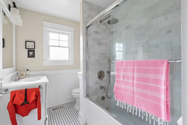 a bathroom with a sink toilet vanity and shower