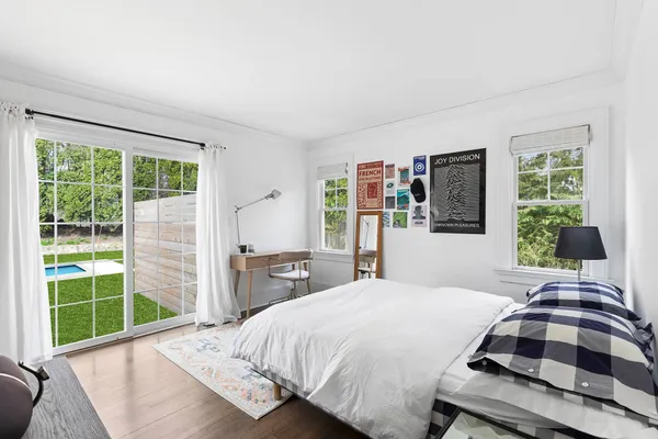 a bedroom with a bed and a window