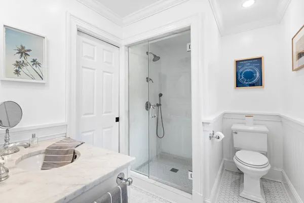 a bathroom with a toilet a sink and shower