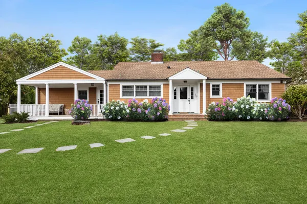 a front view of a house with a yard table and chairs