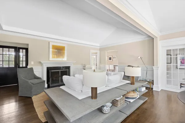 a living room with furniture fireplace and a table