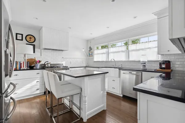 a kitchen with a sink cabinets and window