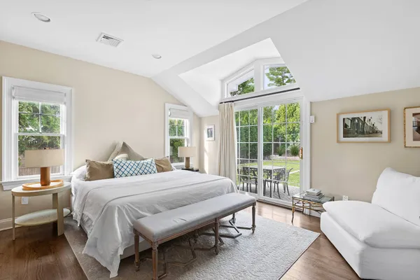 a bedroom with a bed and a large window