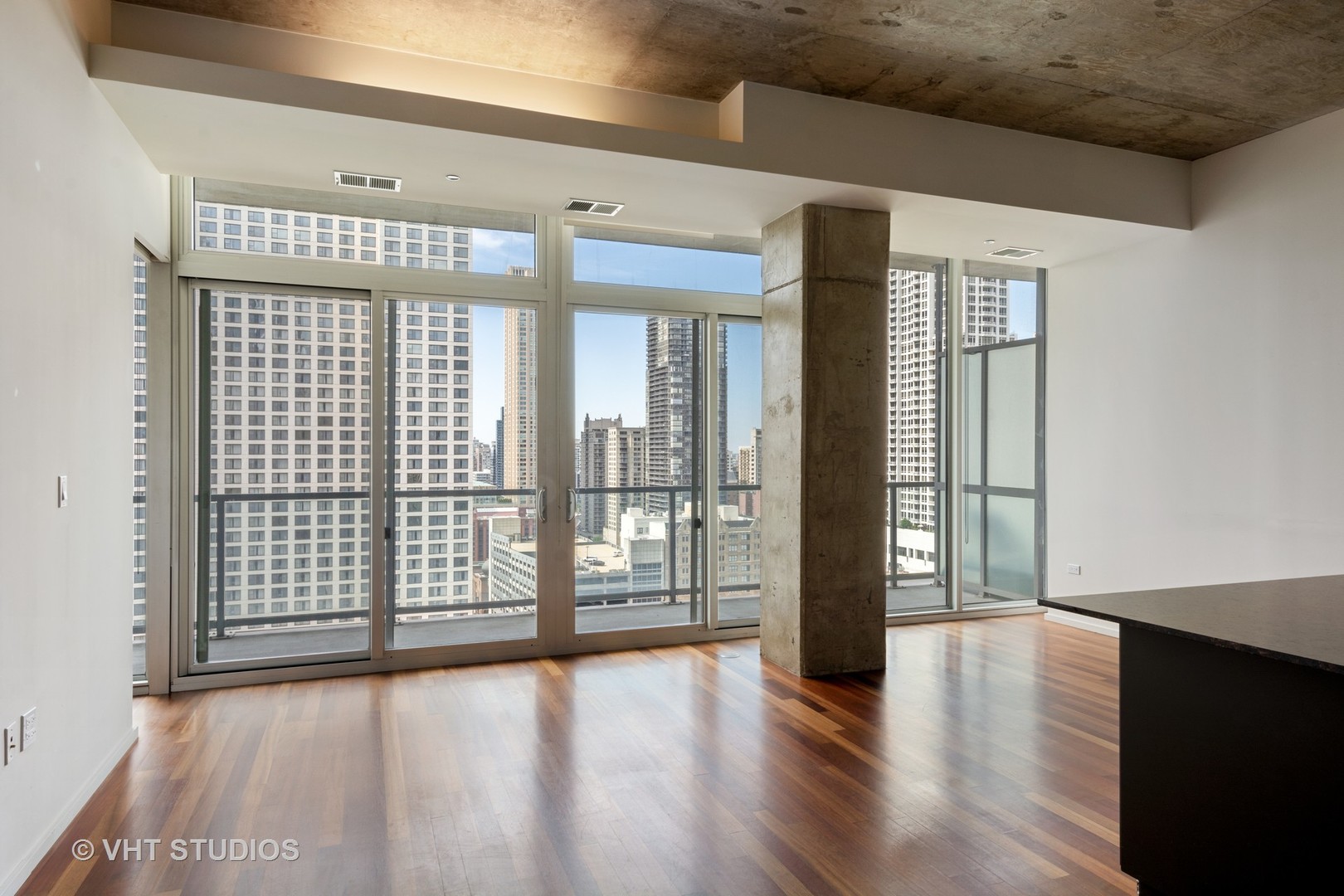 550 North St Clair Street, Unit 2105 Chicago, IL 60611 - Photo 2 of 12 a view of an empty room with wooden floor and a window