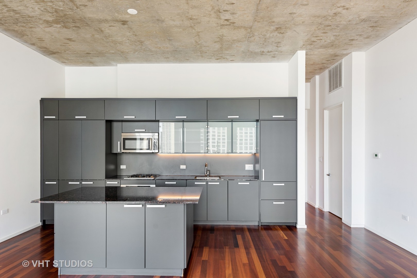 550 North St Clair Street, Unit 2105 Chicago, IL 60611 - Photo 3 of 12 a kitchen with granite countertop a sink and cabinets