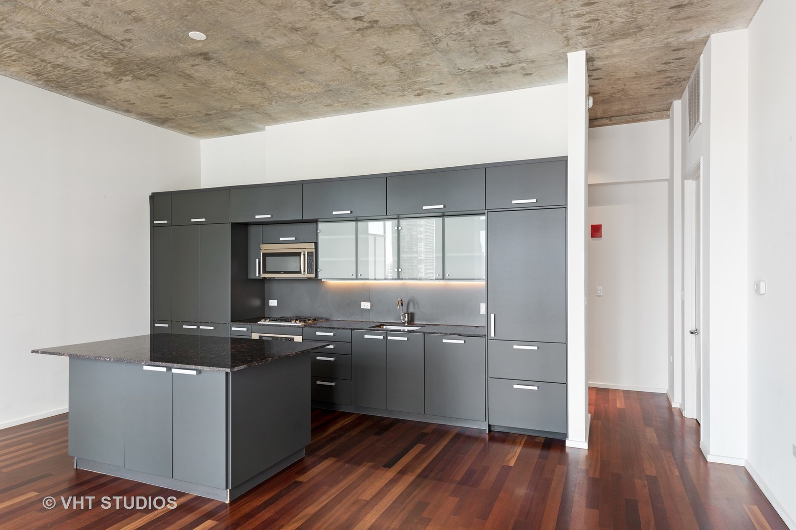 550 North St Clair Street, Unit 2105 Chicago, IL 60611 - Photo 4 of 12 a kitchen with cabinets and wooden floor