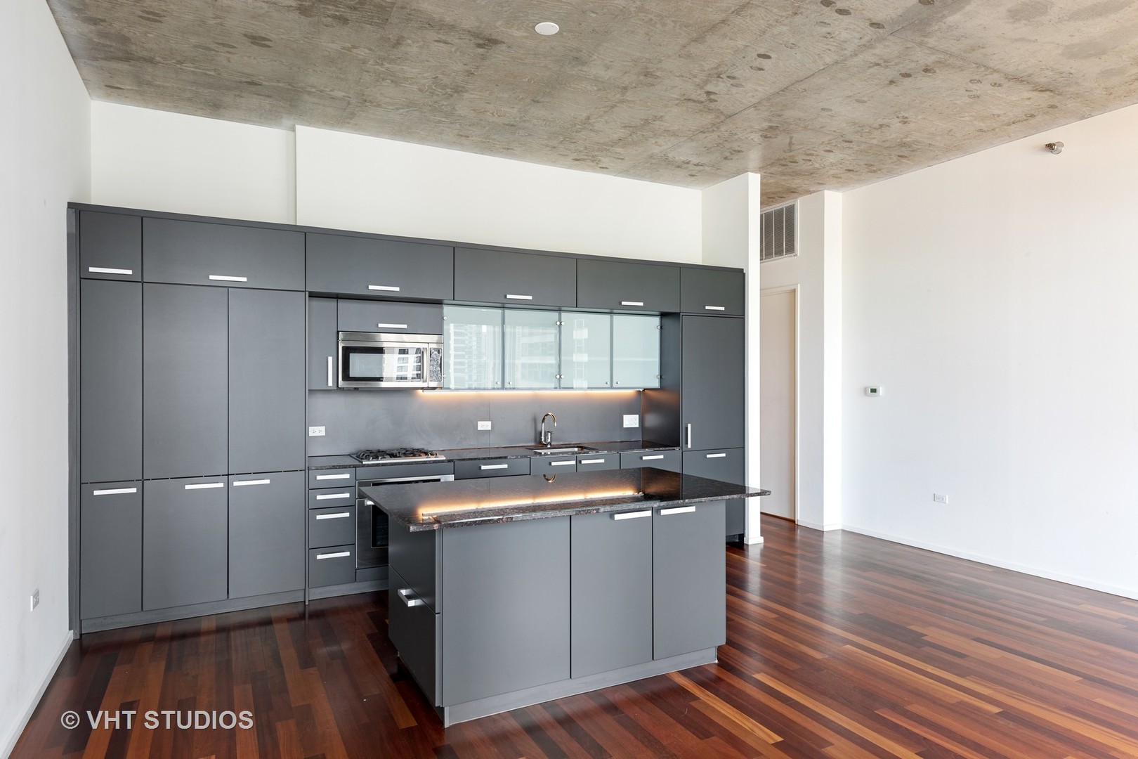 550 North St Clair Street, Unit 2105 Chicago, IL 60611 - Photo 5 of 12 a kitchen with a sink a refrigerator and wooden floor