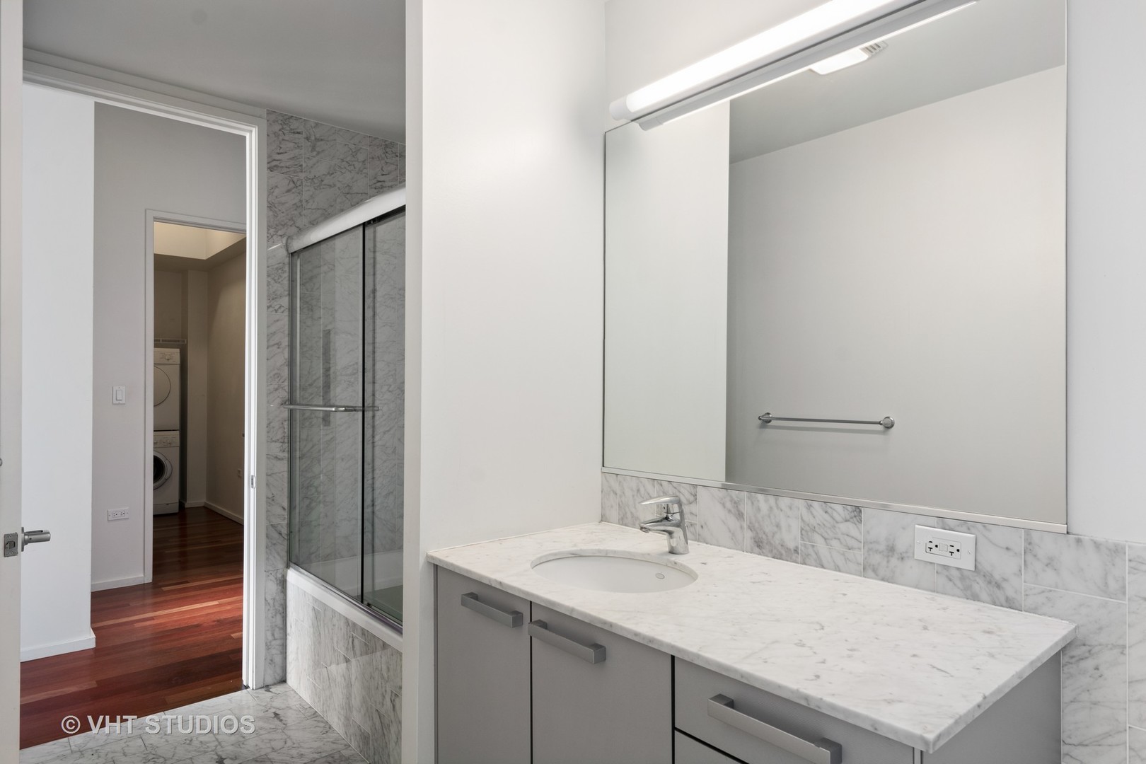 550 North St Clair Street, Unit 2105 Chicago, IL 60611 - Photo 10 of 12 a bathroom with a sink and a mirror