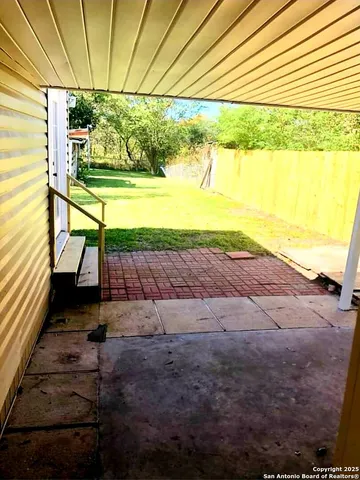 a view of a porch with furniture and a yard