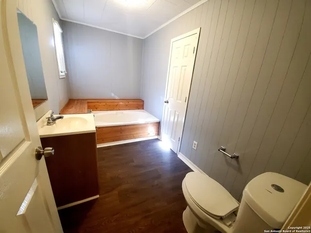 a bathroom with a sink mirror vanity and toilet