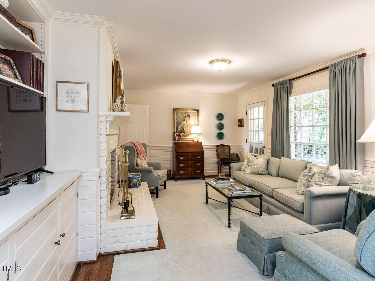 3209 Northampton Street Raleigh, NC 27609 - Photo 13 of 31 a living room with furniture and a flat screen tv