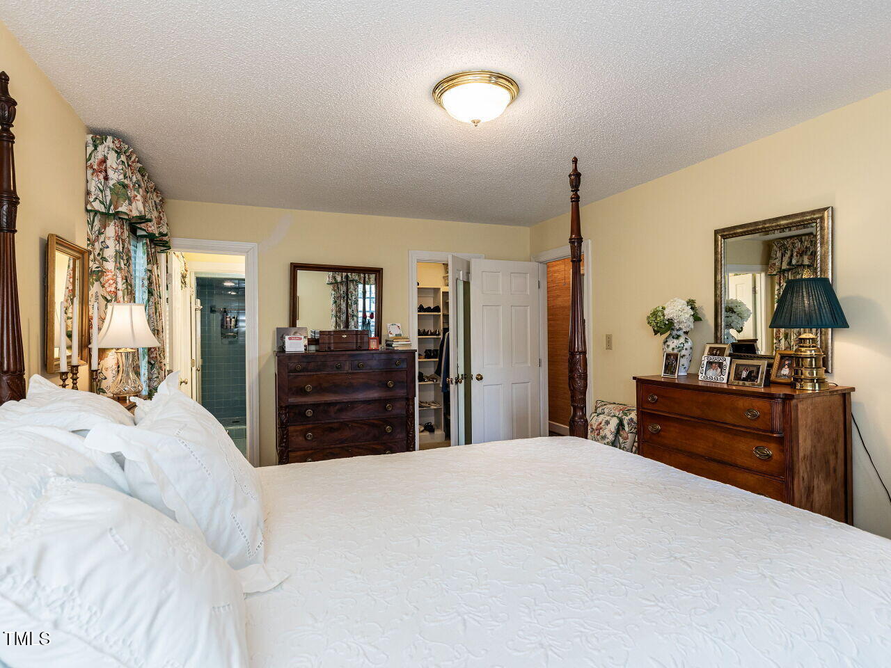 3209 Northampton Street Raleigh, NC 27609 - Photo 23 of 31 a bedroom with a large bed and a dresser