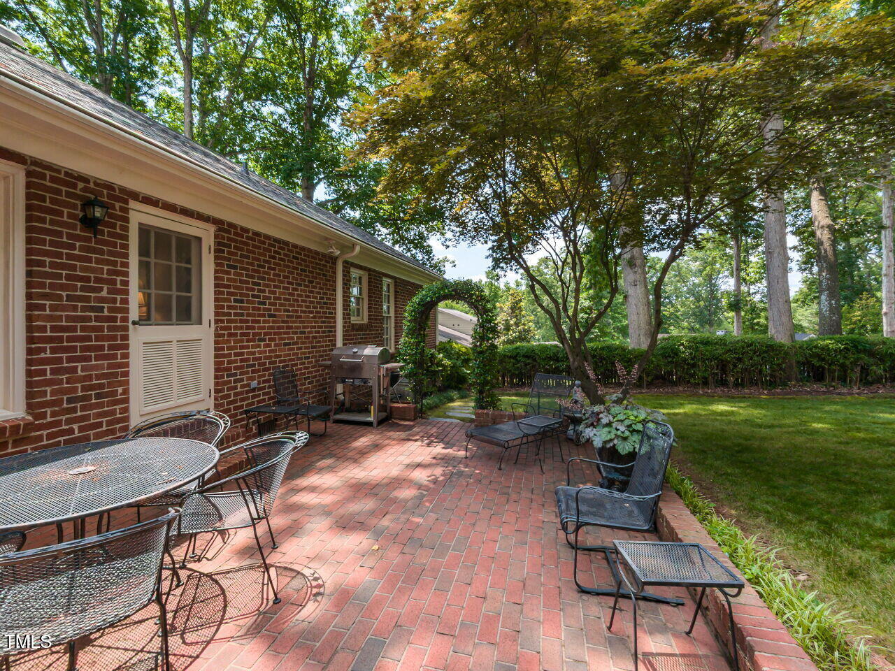 3209 Northampton Street Raleigh, NC 27609 - Photo 30 of 31 a backyard of a house with table and chairs