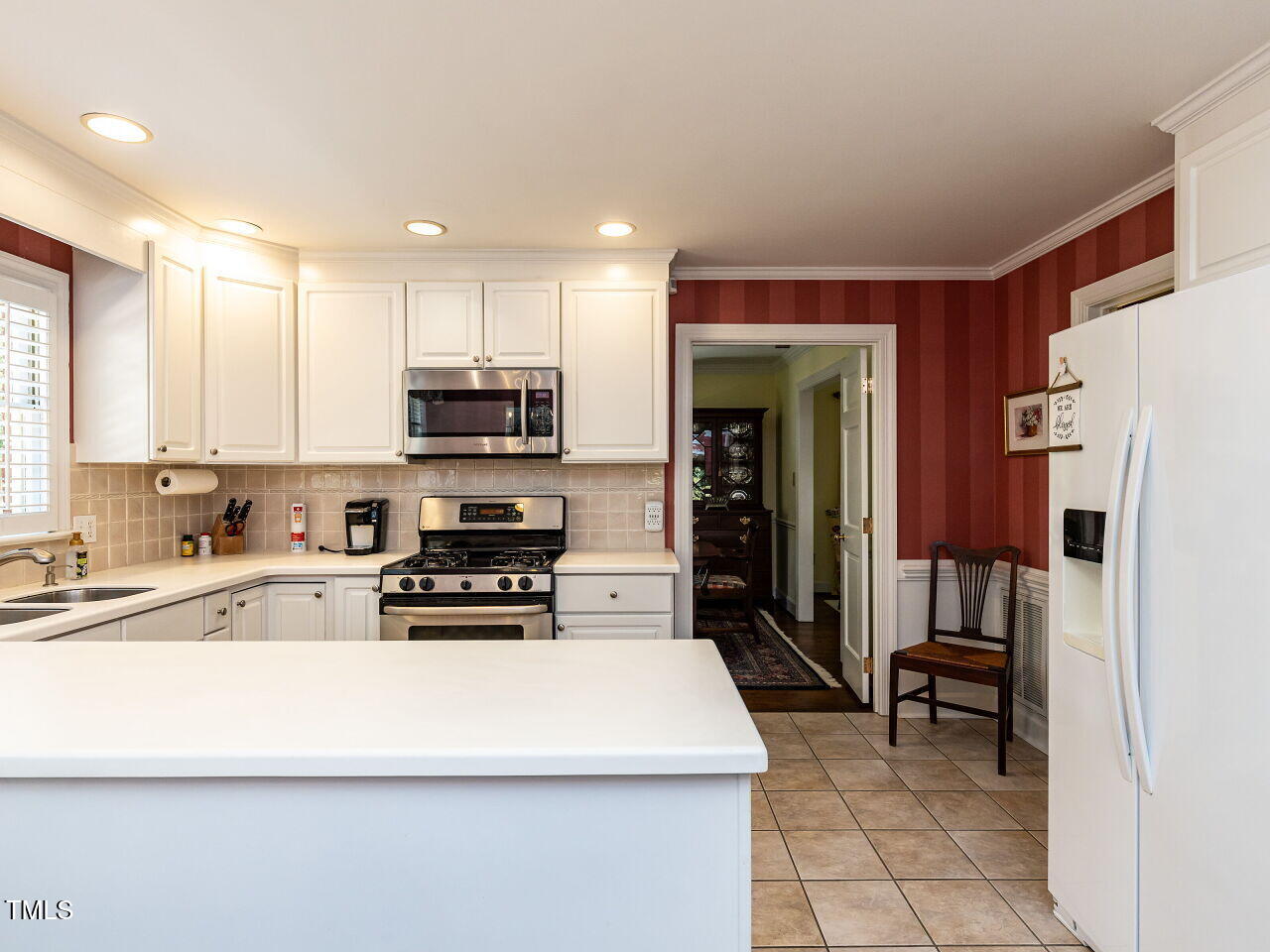 3209 Northampton Street Raleigh, NC 27609 - Photo 3 of 31 a kitchen with stainless steel appliances granite countertop a refrigerator and a stove top oven