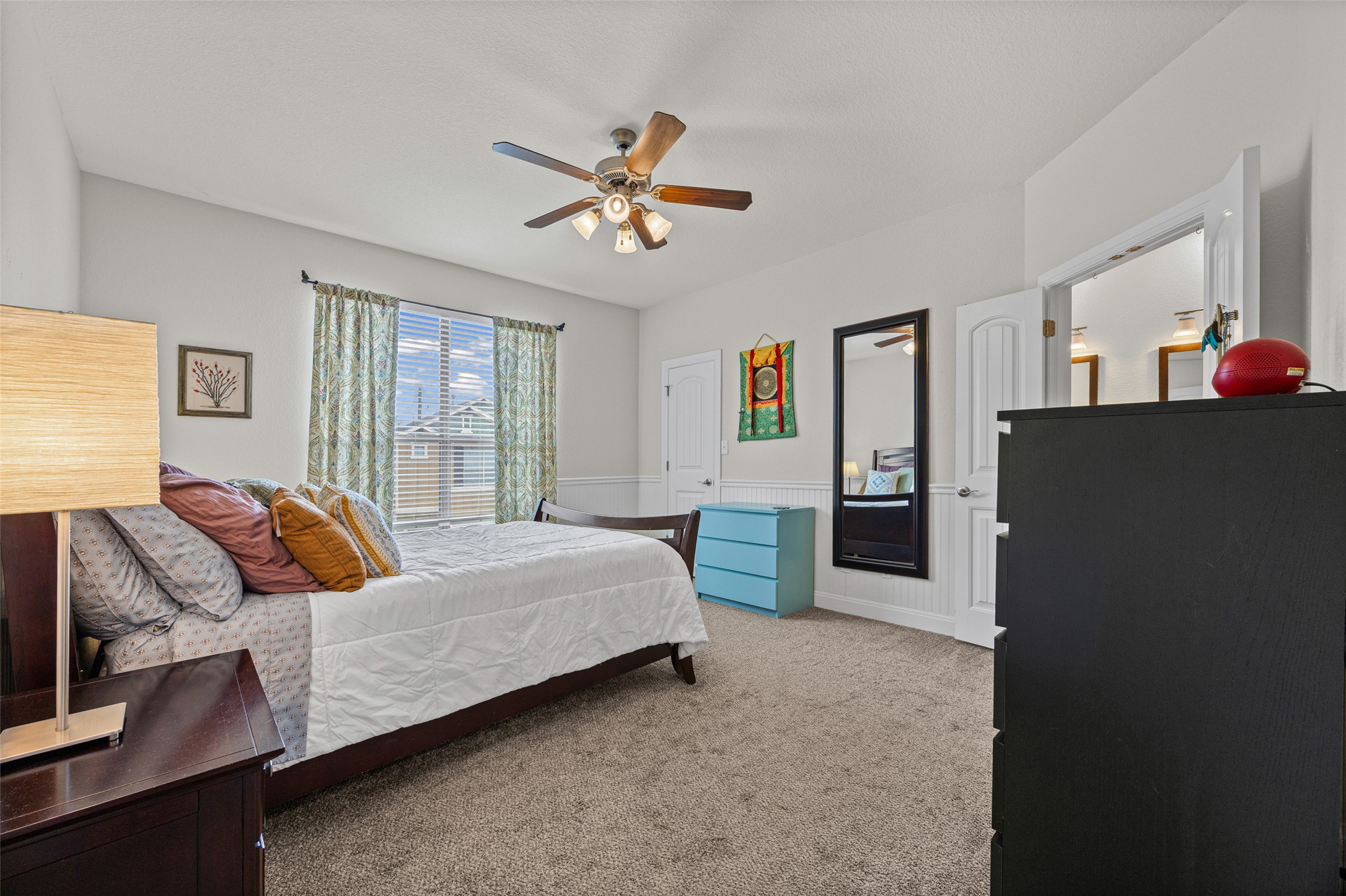 6708 Menchaca Road, Unit 10 Austin, TX 78745 - Photo 17 of 30 The Primary Bedroom with carpet and a ceiling fan.