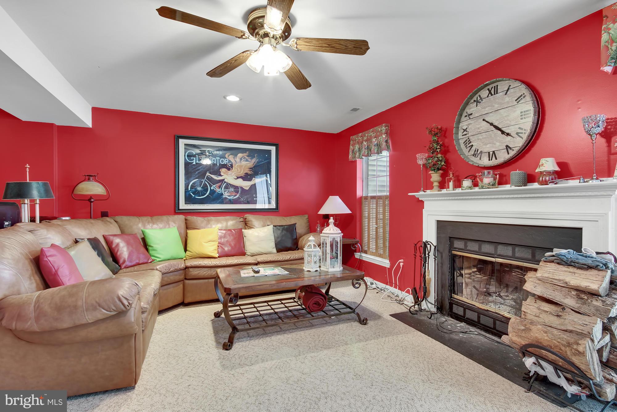 139 Gentlebrook Road Owings Mills, MD 21117 - Photo 21 of 30 a living room with furniture a clock and a fireplace