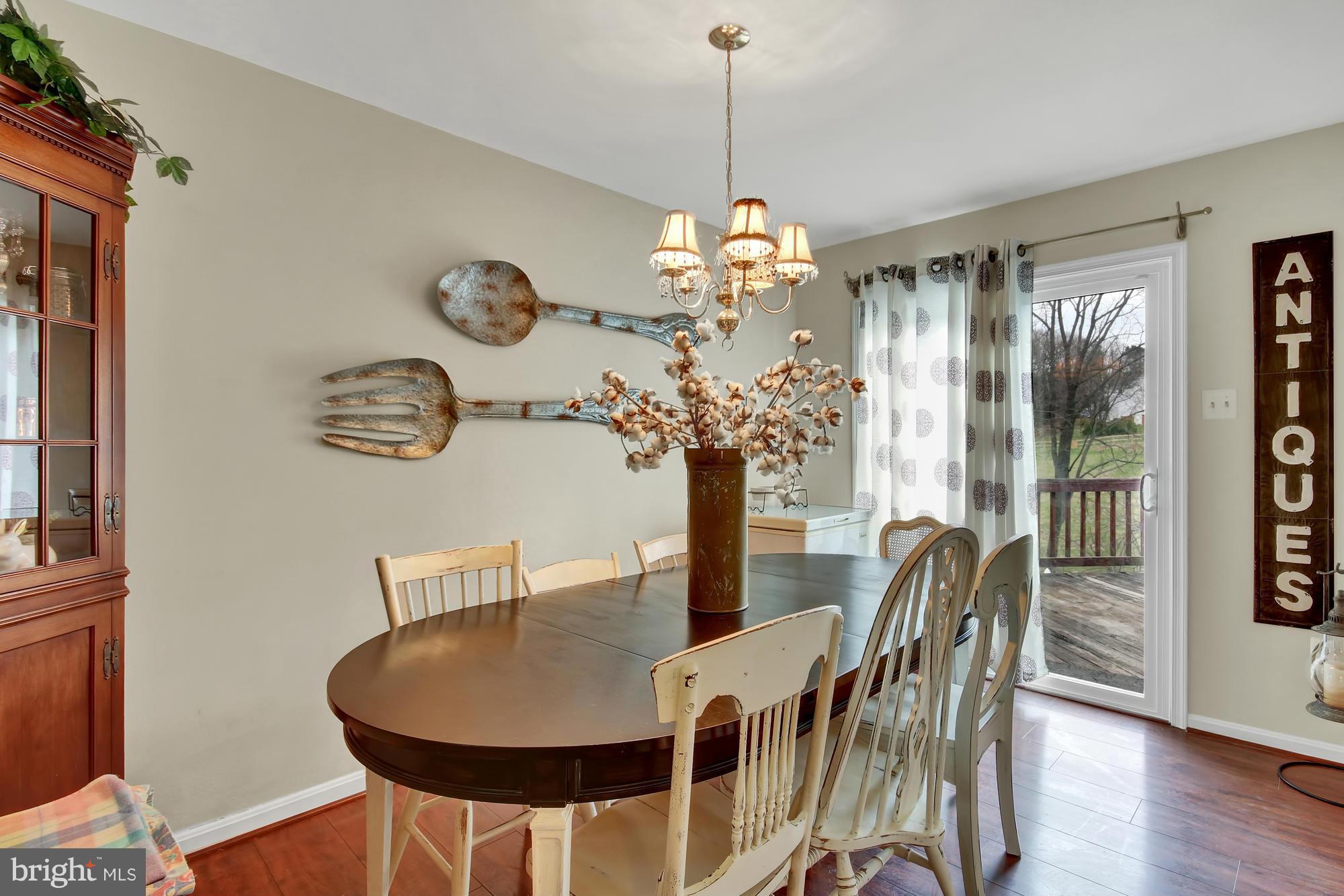 139 Gentlebrook Road Owings Mills, MD 21117 - Photo 6 of 30 a view of a dining room with furniture a chandelier window and wooden floor