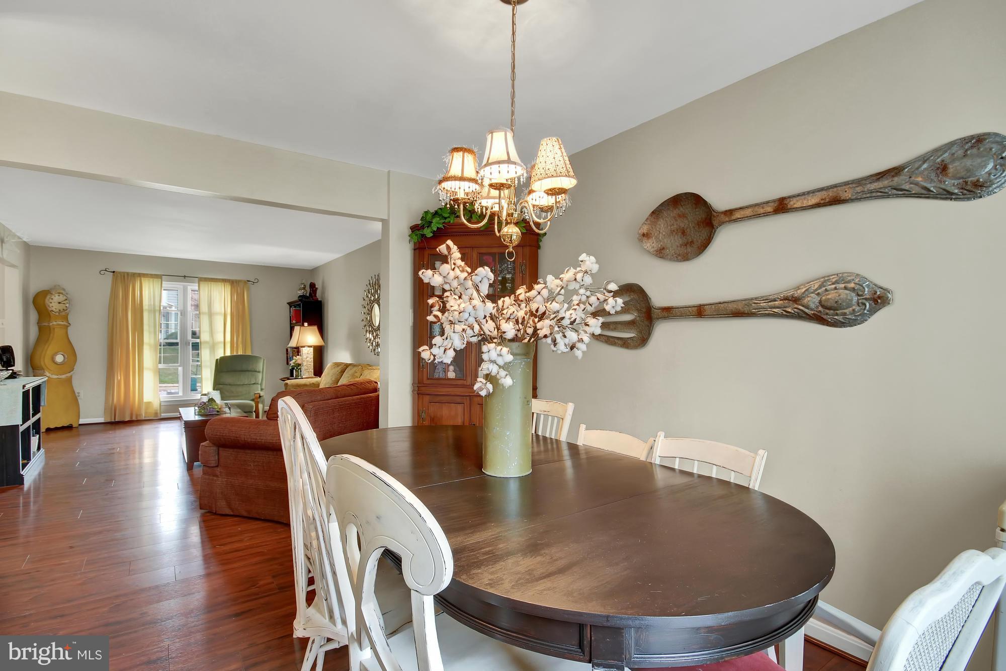 139 Gentlebrook Road Owings Mills, MD 21117 - Photo 7 of 30 a dining room with furniture a chandelier and wooden floor