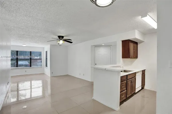 a kitchen with a sink stove and microwave
