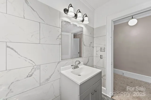 an empty room with wooden floor ceiling fan and windows