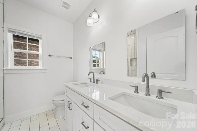 a bathroom with a sink shower and a mirror