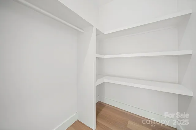 a view of an empty room and wooden floor