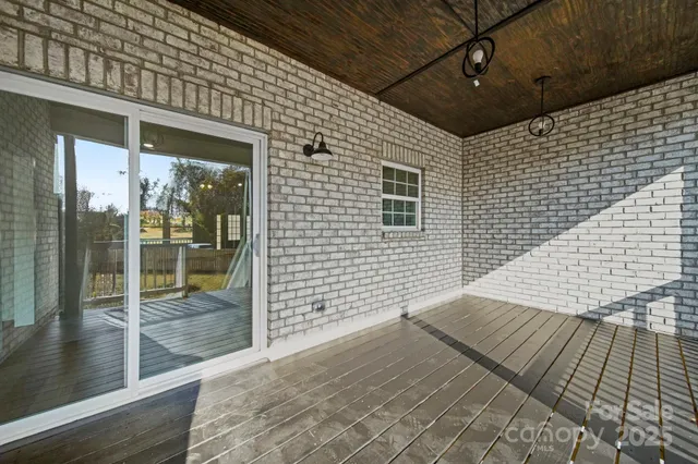 a view of a balcony with wooden floor