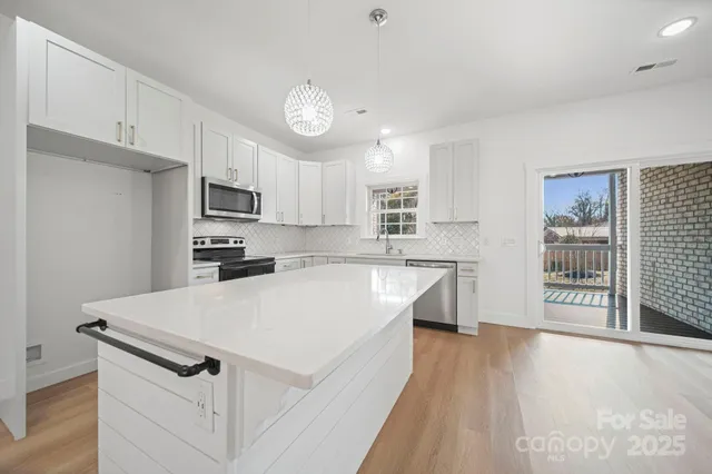 a view of a sink and cabinet with wooden floor