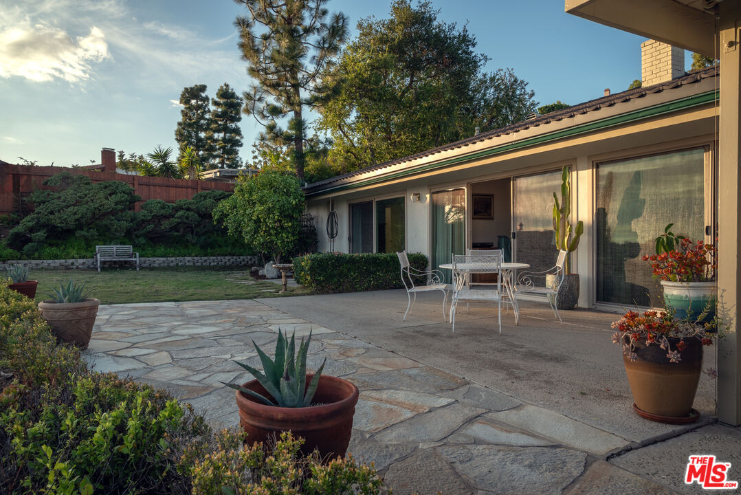 2701 Lake Hollywood Drive Los Angeles, CA 90068 - Photo 11 of 41 a view of a patio with table and chairs potted plants and a fountain