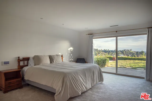 a bedroom with a large bed and a large window