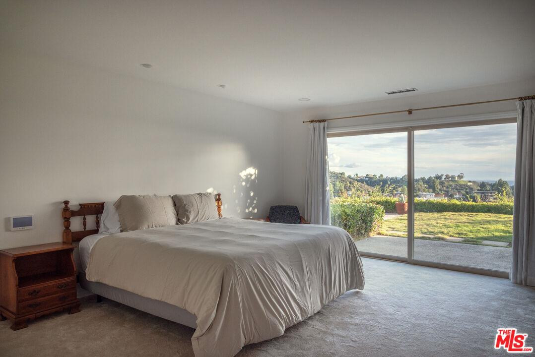 2701 Lake Hollywood Drive Los Angeles, CA 90068 - Photo 19 of 41 a bedroom with a large bed and a large window