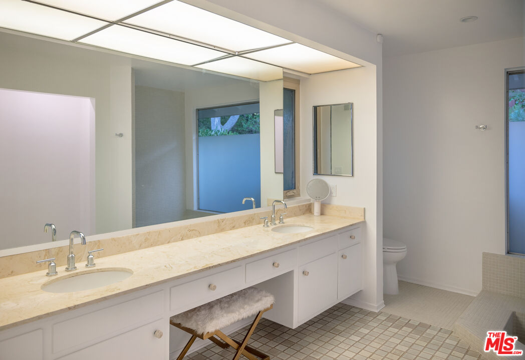 2701 Lake Hollywood Drive Los Angeles, CA 90068 - Photo 21 of 41 a bathroom with a granite countertop sink and a mirror
