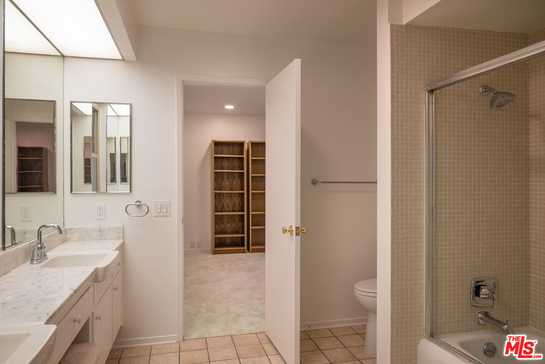 2701 Lake Hollywood Drive Los Angeles, CA 90068 - Photo 35 of 41 a bathroom with a granite countertop sink a toilet and shower