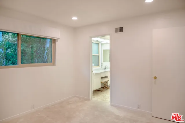 an empty room with a bathroom and a sink