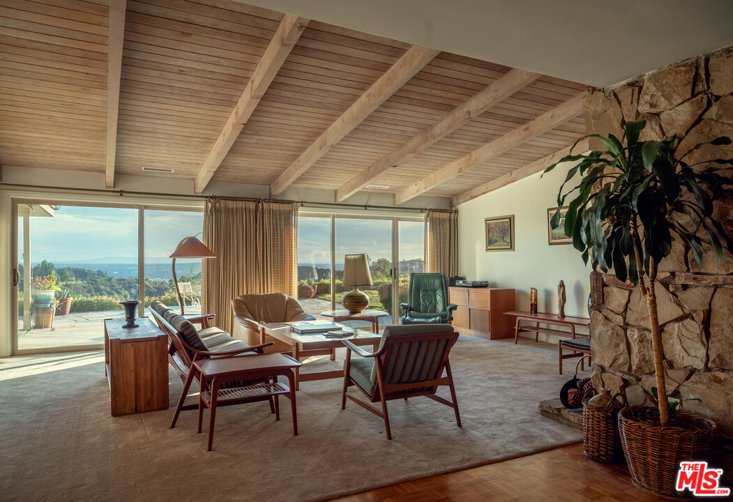 2701 Lake Hollywood Drive Los Angeles, CA 90068 - Photo 4 of 41 a living room with patio furniture and a floor to ceiling window