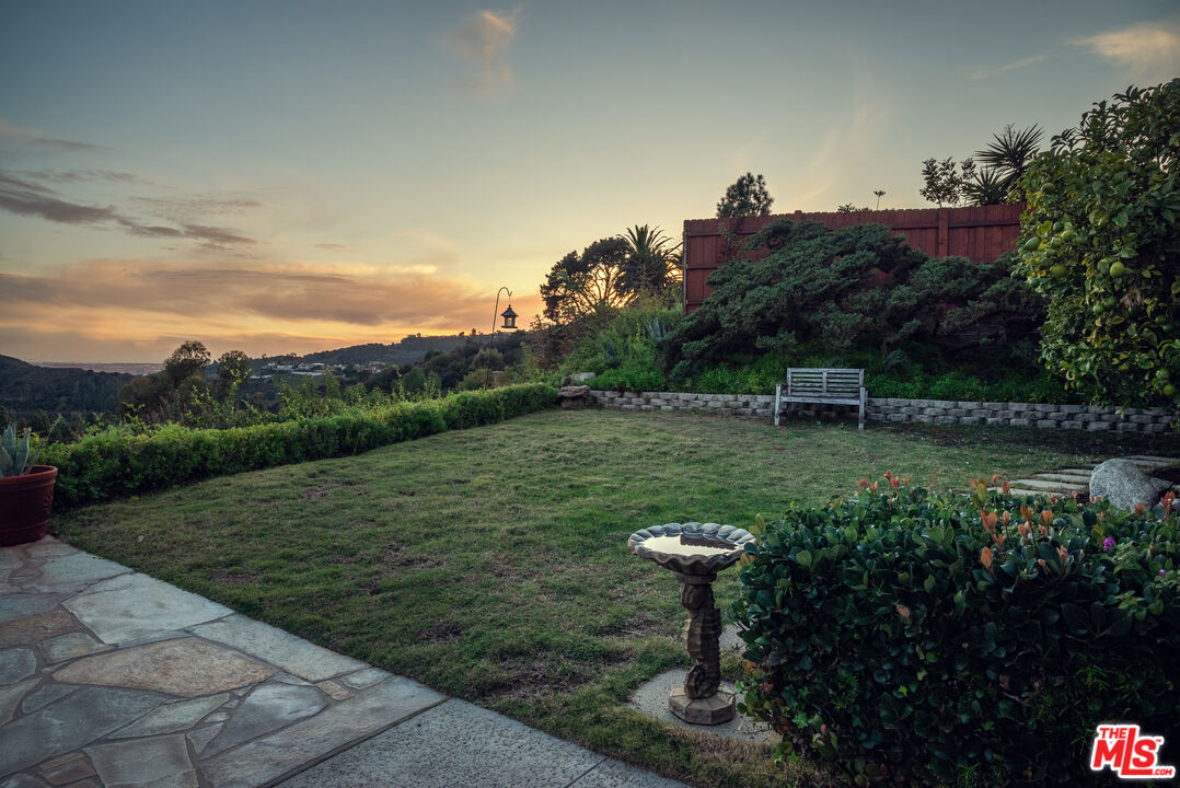 2701 Lake Hollywood Drive Los Angeles, CA 90068 - Photo 10 of 41 a view of a garden with a bench in a lake