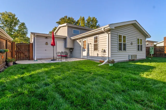 a front view of house with yard and outdoor seating