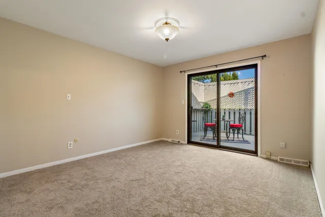 an empty room with floor to ceiling fan and a ceiling fan
