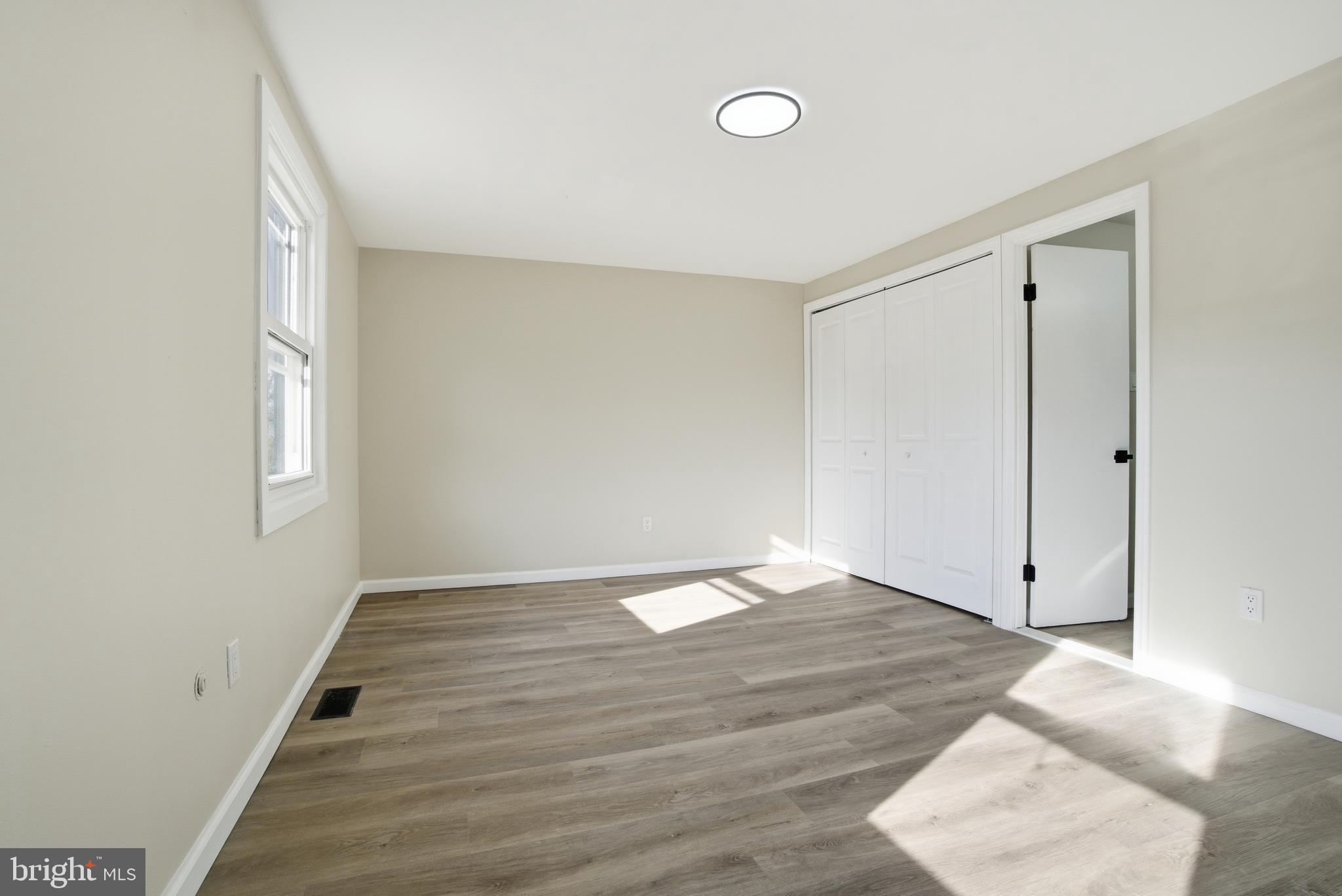 7 Riverview Place Willingboro, NJ 08046 - Photo 17 of 25 a view of an empty room with wooden floor and a window