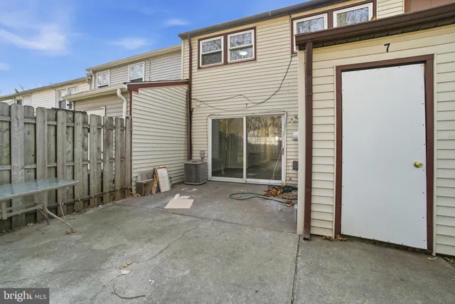 a view of a house with backyard and glass door