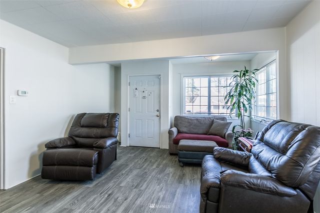 a kitchen with granite countertop white cabinets and white appliances