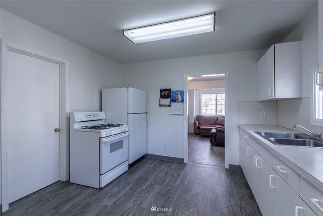 a kitchen with a stove a sink and a refrigerator