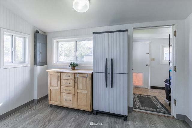 a view of a kitchen with a sink and a refrigerator