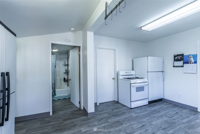 a kitchen with white cabinets and a sink