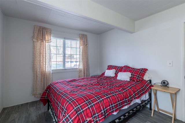 a view of room with lots of stuff and hardwood floor