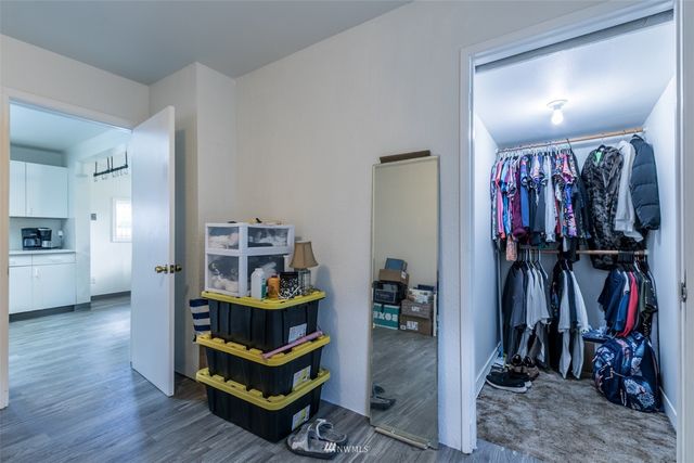 a view of a workspace with furniture and wooden floor