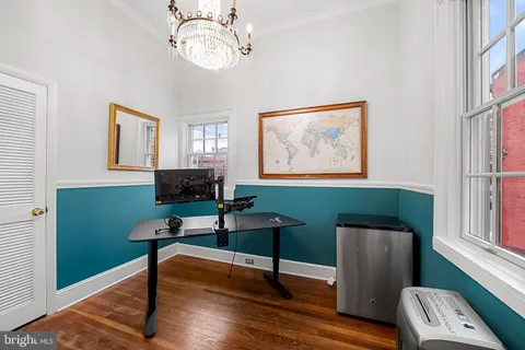 a view of a livingroom with furniture a flat screen tv and wooden floor