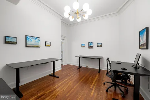 a view of a workspace with furniture and a window