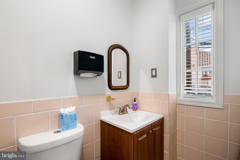a bathroom with a sink a toilet and a mirror